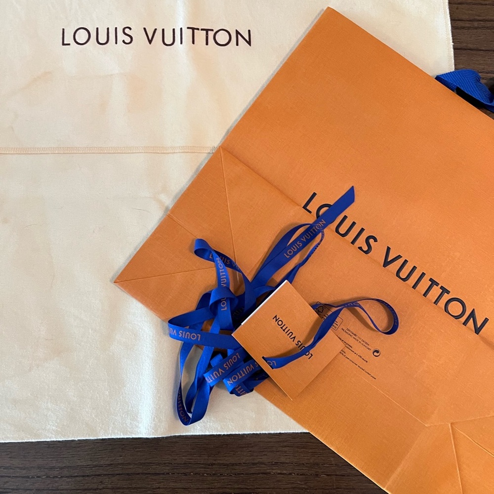 Louis Vuitton shopping bag, ribbon, gift card and dust bag.
